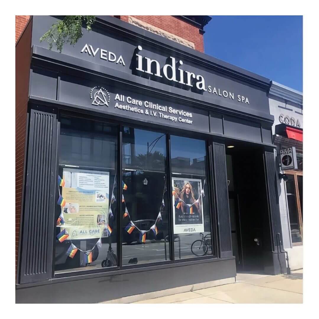 - Indira Salon Spa in Chicago IL, Park Ridge IL, Green Bay WI Storefront of Indira Salon Spa and All Care Clinical Services with signage and colorful paper garlands decorating the windows. - Indira Salon Spa in Chicago IL, Park Ridge IL, Green Bay WI